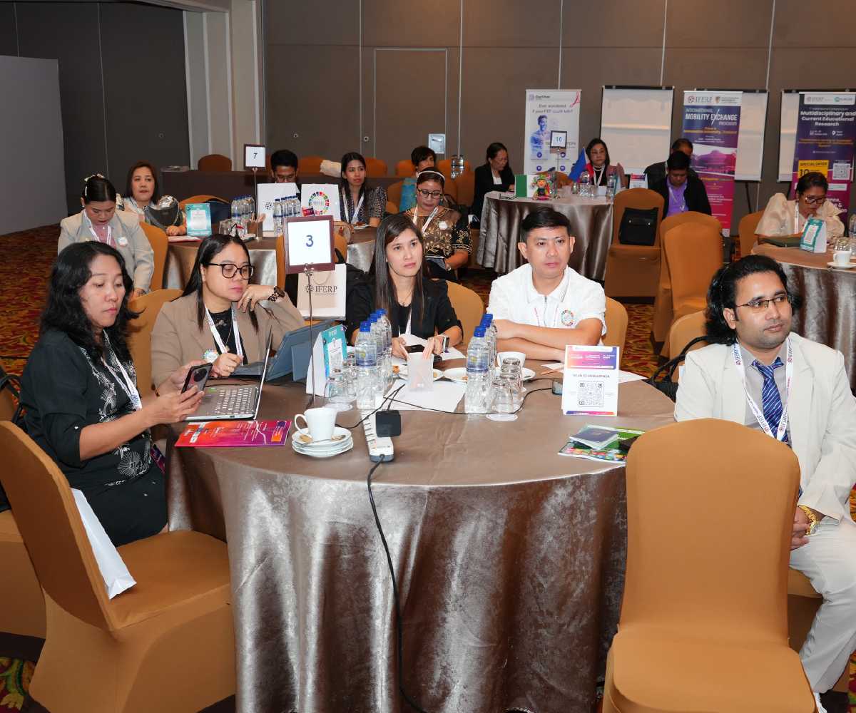 Delegates at a poster session, display boards behind them