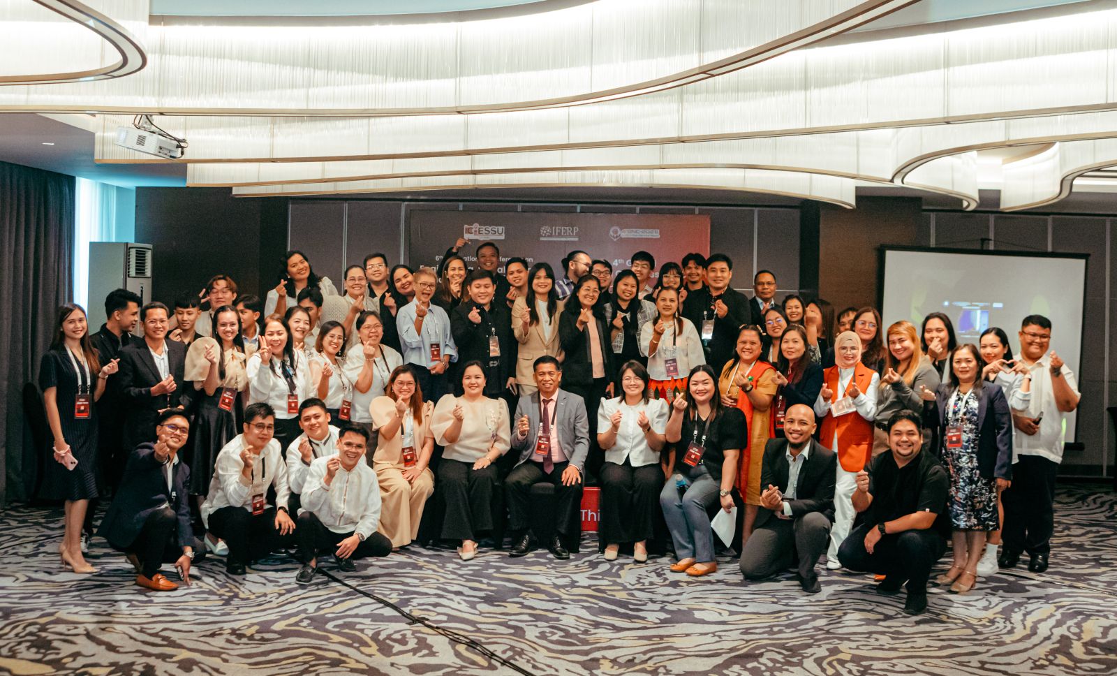 Group photograph of participants and organisers in the conference hall