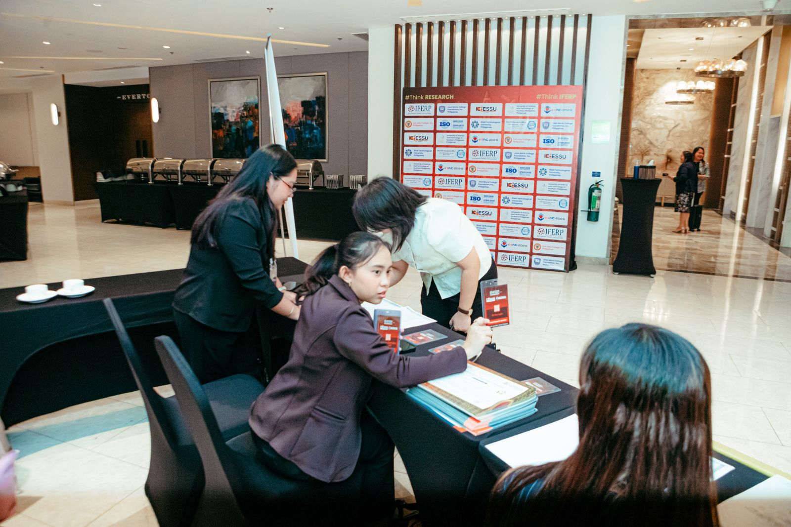 The organising team preparing delegate badges at the registration table